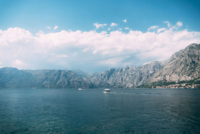 Scenic view of sea and mountains against sky