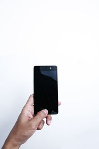 Hand holding smart phone against white background