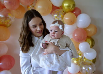 Mother celebrating christening of little baby girl