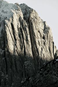 Low angle view of rocky mountains against clear sky