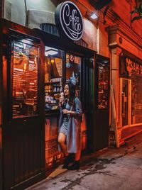 People in illuminated store at night