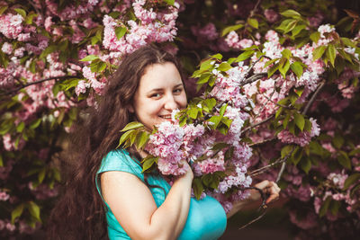 Smiling woman with pink flowers