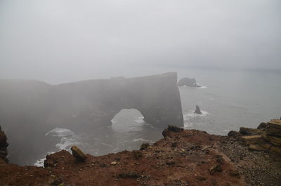 Scenic view of sea and mountains against sky