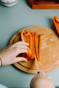 High angle view of person holding bread in plate