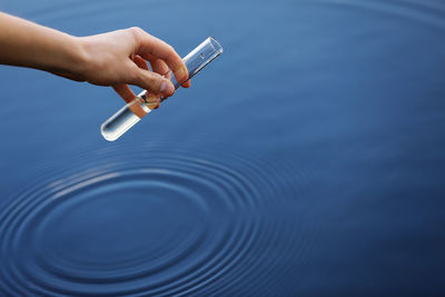 Cropped hand of woman holding water