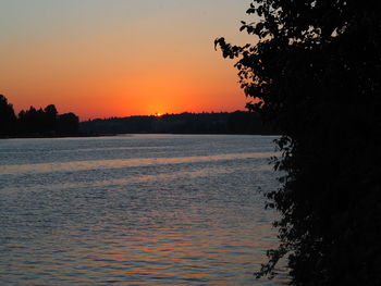 Scenic view of lake against orange sky