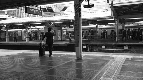 People standing on railroad station platform