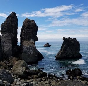 Scenic view of rock formation in sea against sky