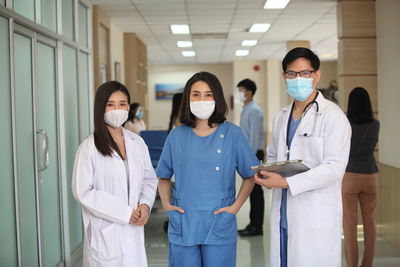 Portrait of friends standing in corridor