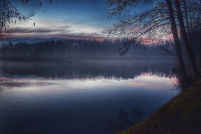 Scenic view of lake against cloudy sky