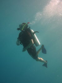 Full length of man scuba diving in sea