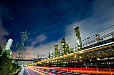 Light trails on road against sky at night