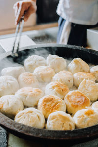 Midsection of person preparing food in kitchen