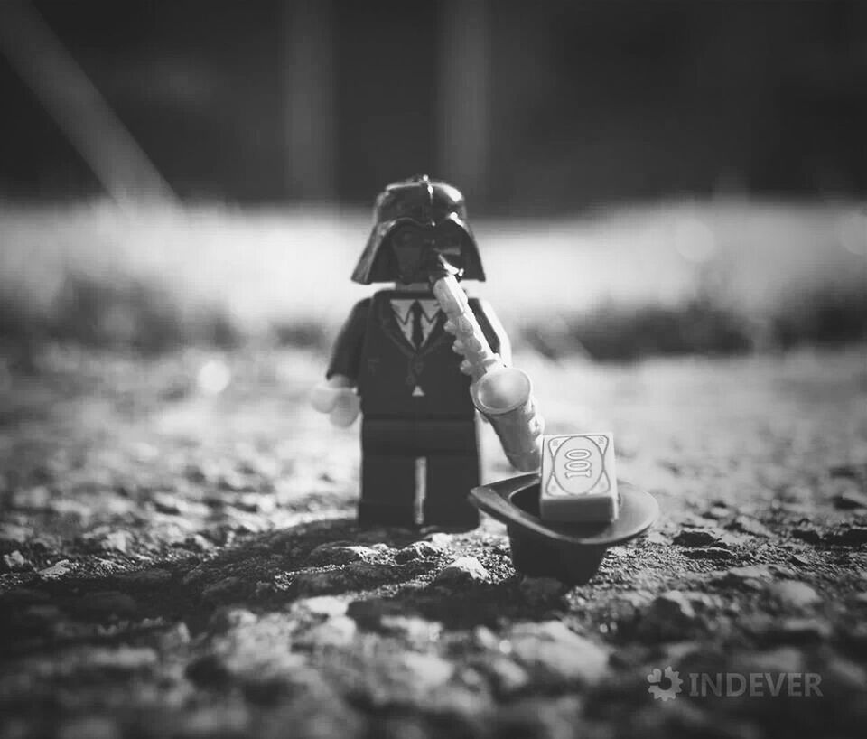 focus on foreground, selective focus, field, toy, day, outdoors, childhood, close-up, human representation, leisure activity, lifestyles, grass, holding, figurine, hat, still life, protection, shoe