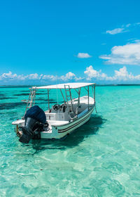 Boat in sea against blue sky