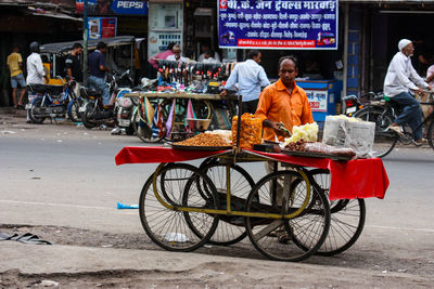 People with bicycle on road in city