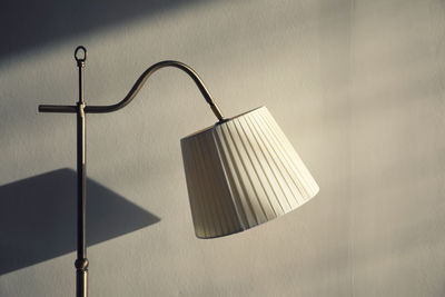 Close-up of electric lamp hanging on wall