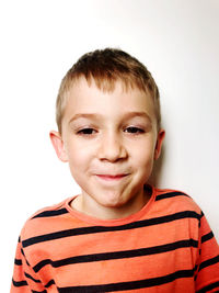 Portrait of smiling boy against white background