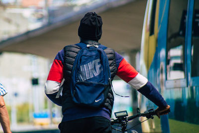 Rear view of man with bicycle