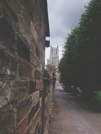 Walkway amidst buildings in city