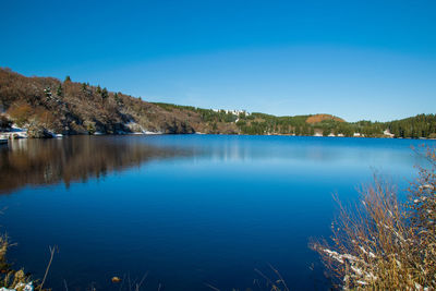 Scenic view of lake against blue sky