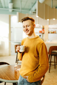 Man holding coffee cup