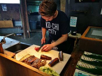 Man preparing food in commercial kitchen