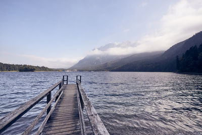 Pier over lake against sky