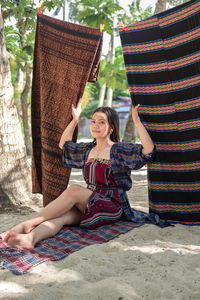 Portrait of young woman sitting on hammock
