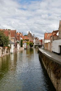 River amidst houses against sky