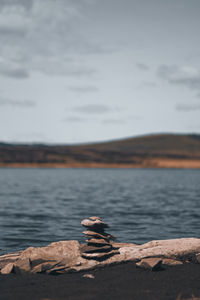 Rocks on beach against sky