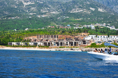 Scenic view of sea against buildings