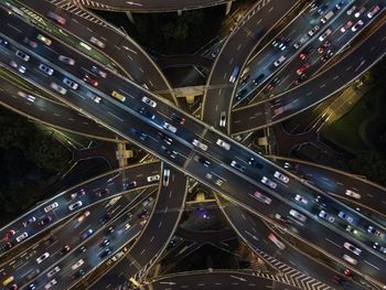 High drone view of illuminated road with traffic jam at elevated yan'an intersection in shanghai.