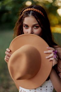 Portrait of young woman wearing hat