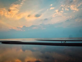 Scenic view of lake against sky at sunset