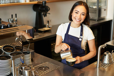 Portrait of young woman working in workshop