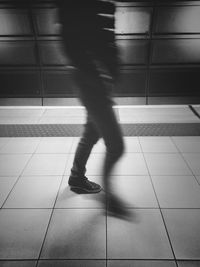 Low section of woman walking on tiled floor