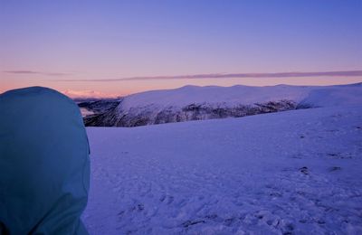 Scenic view of snow covered mountains against sky during sunset