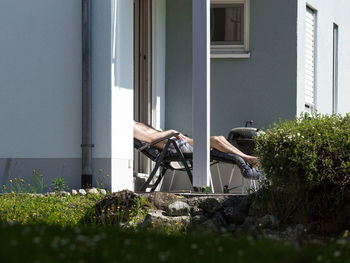 Low section of man resting on deck chair