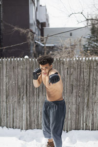 Young male boxer posing in the snow