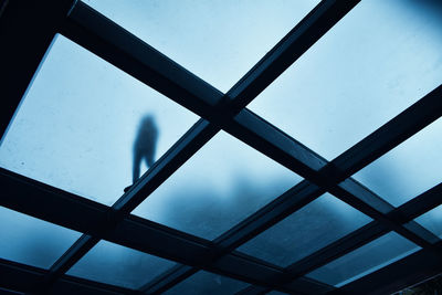 Low section of person standing on skylight
