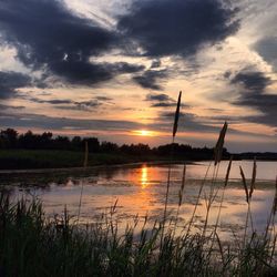 Scenic view of lake at sunset