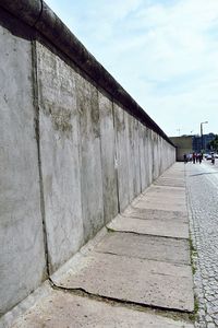 Man walking on road against sky