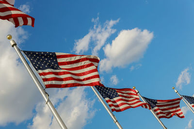 Low angle view of flags against sky