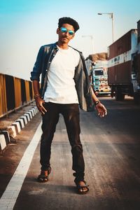 Full length portrait of young man standing outdoors