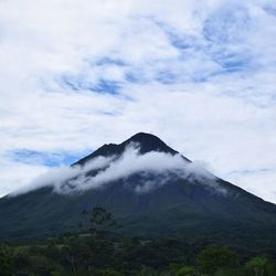 Low angle view of volcanic mountain against sky