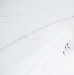 People skiing on snow covered land