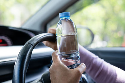 Cropped hand of man holding drink