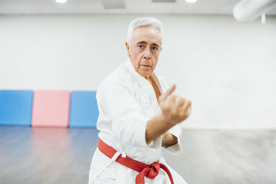 Senior karate master performing combat techniques