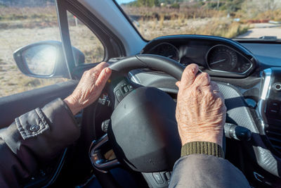 Midsection of man driving car